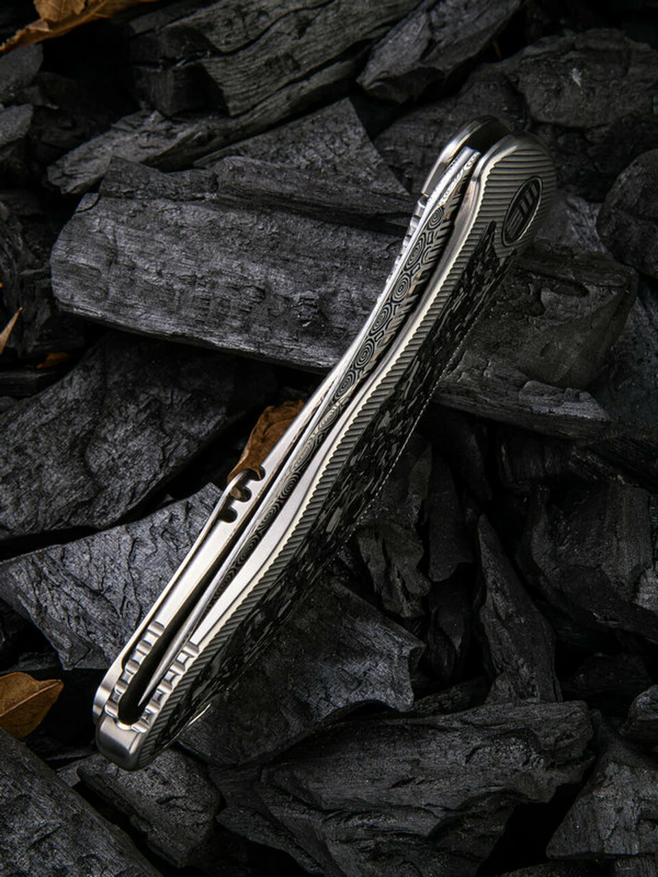 We Knife Co. We Knife Synergy 2 Framelock Folder 912CFDS2, 3.49" Heimskringla Damasteel Tanto Plain Blade, 6AL4V Titanium with Shredded Carbon Fiber Inlay Handle 5 We Knife Co. We Knife Synergy 2 Framelock Folder 912CFDS2, 3.49" Heimskringla Damasteel Tanto Plain Blade, 6AL4V Titanium with Shredded Carbon Fiber Inlay Handle - Image 5